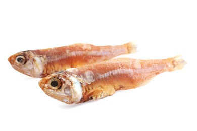 Photo of Delicious dried salted anchovies on white background