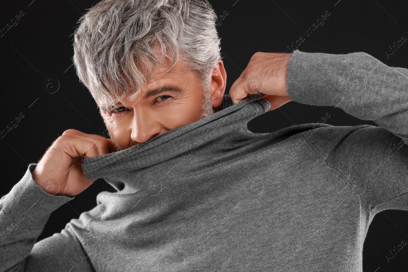 Photo of Portrait of man with beautiful hairstyle on black background