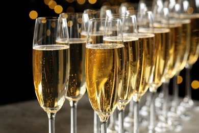 Many glasses of champagne on blurred background, closeup