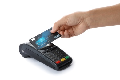 Woman using terminal for contactless payment with credit card on white background