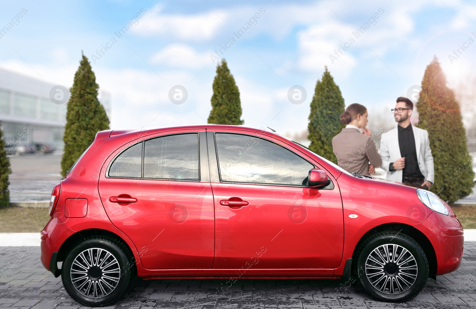 Image of Customers buying car. Modern red auto and couple