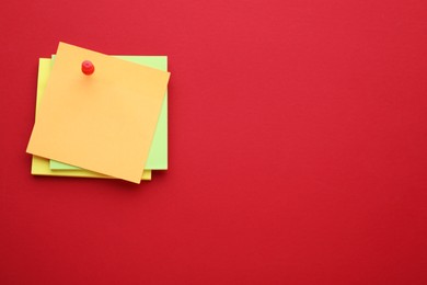 Photo of Paper notes on red background, top view. Space for text
