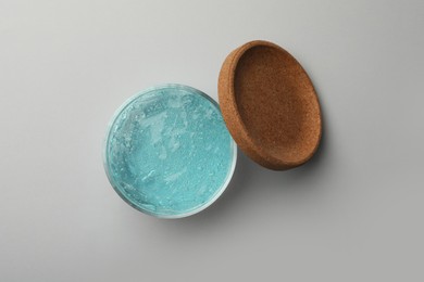 Photo of Jar of blue cosmetic gel on light background, top view