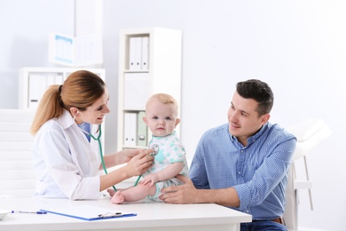 Man with his baby visiting children's doctor in hospital