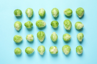 Photo of Fresh Brussels sprouts on color background, flat lay