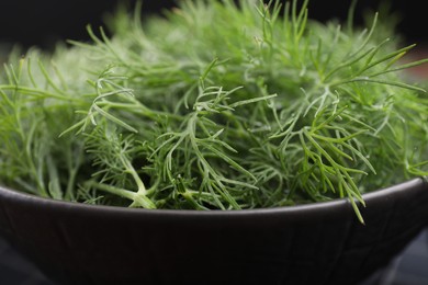 Bowl of fresh dill on table, closeup view