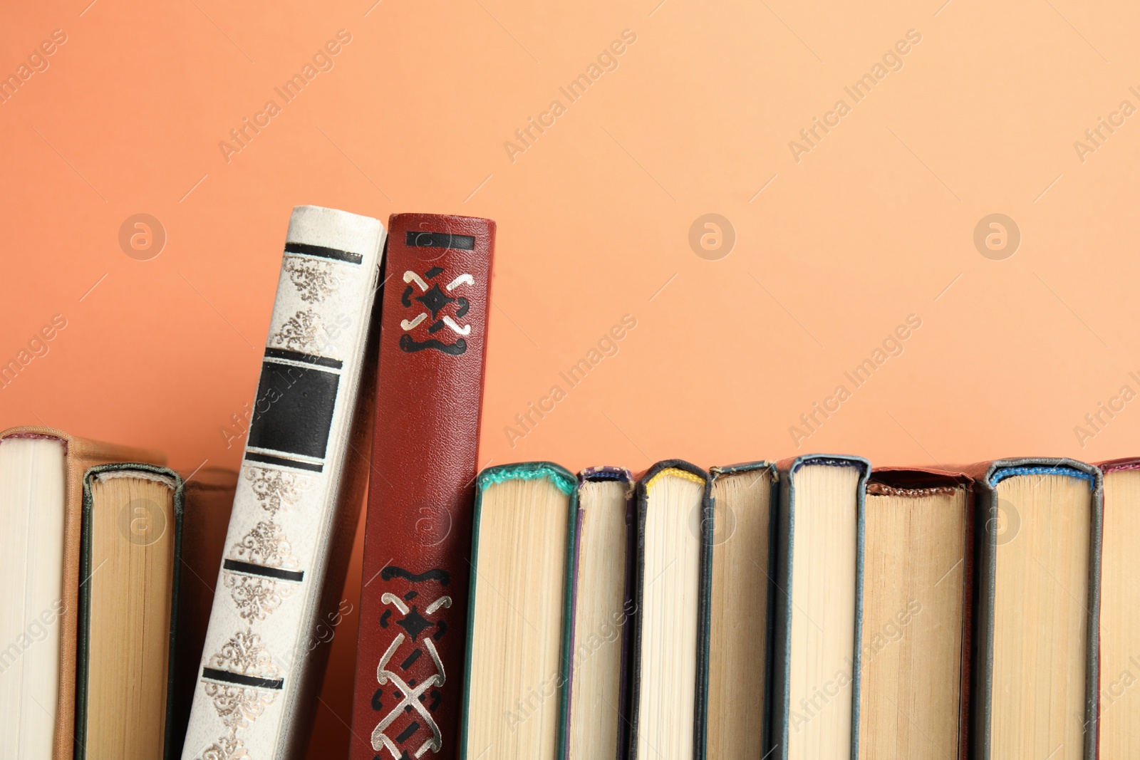 Photo of Collection of old books on peach background