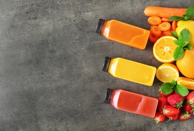 Photo of Flat lay composition with tasty juices and ingredients on grey background