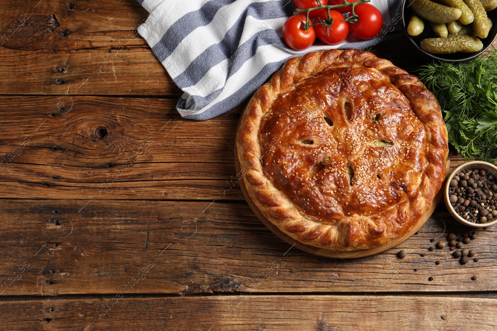 Photo of Tasty homemade pie and ingredients on wooden table, flat lay. Space for text