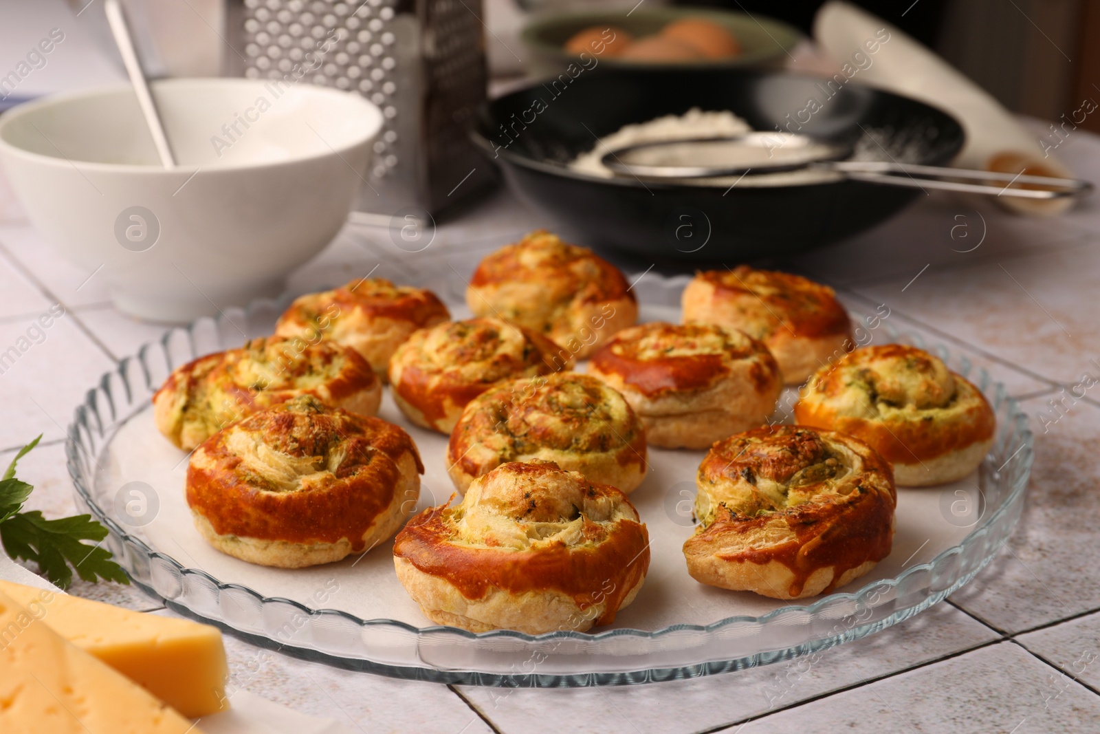 Photo of Fresh delicious puff pastry with tasty filling on white tiled surface