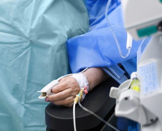 Photo of Doctor preparing patient for surgery in operating room, closeup