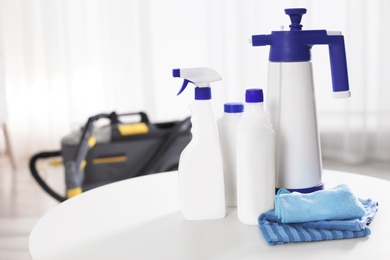 Set of professional cleaning supplies on table indoors. Space for text