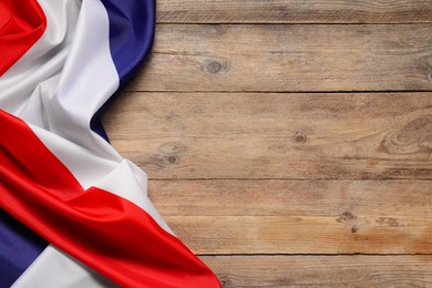 Photo of Flag of France on wooden background, top view. Space for text