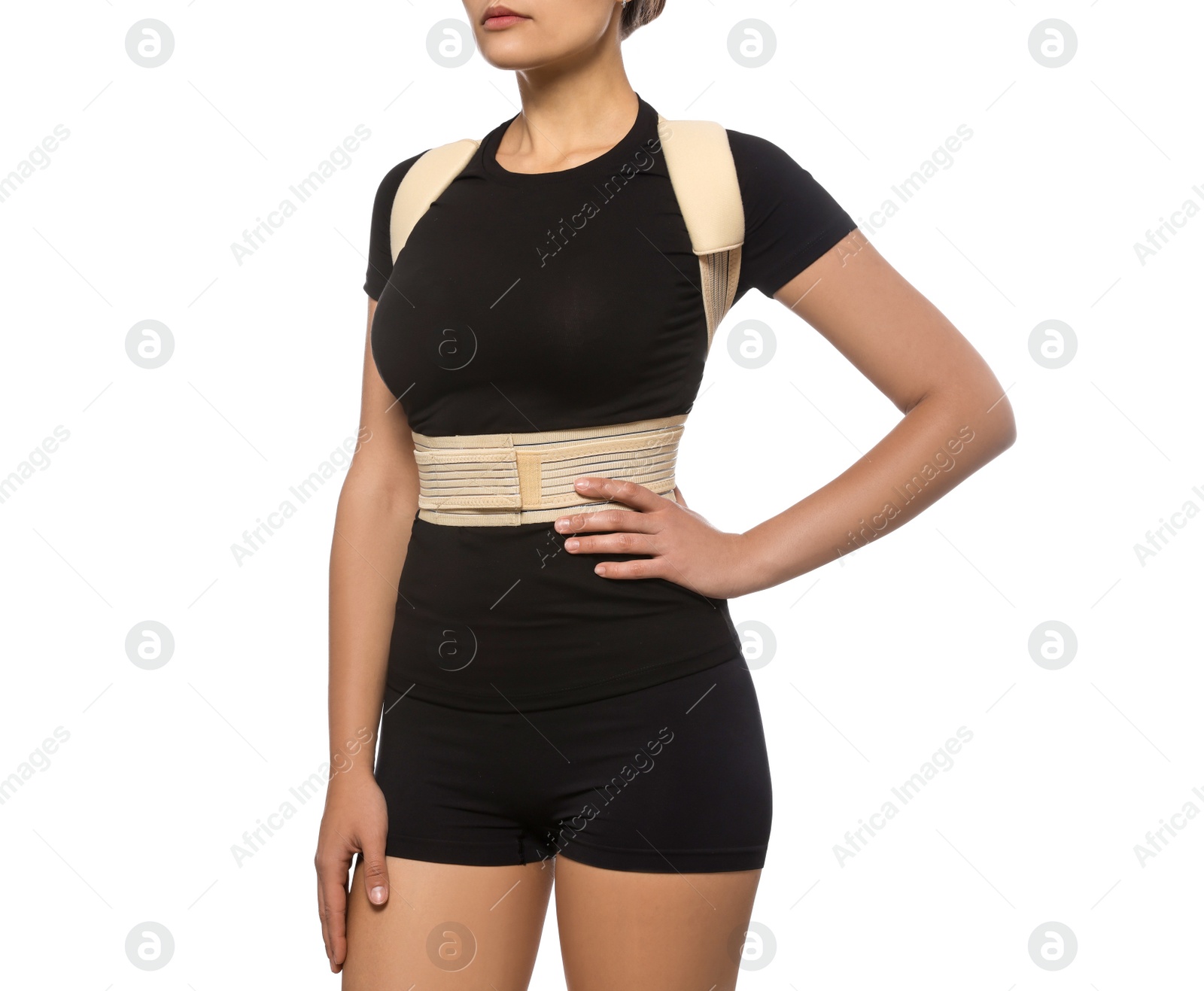 Photo of Closeup view of woman with orthopedic corset on white background