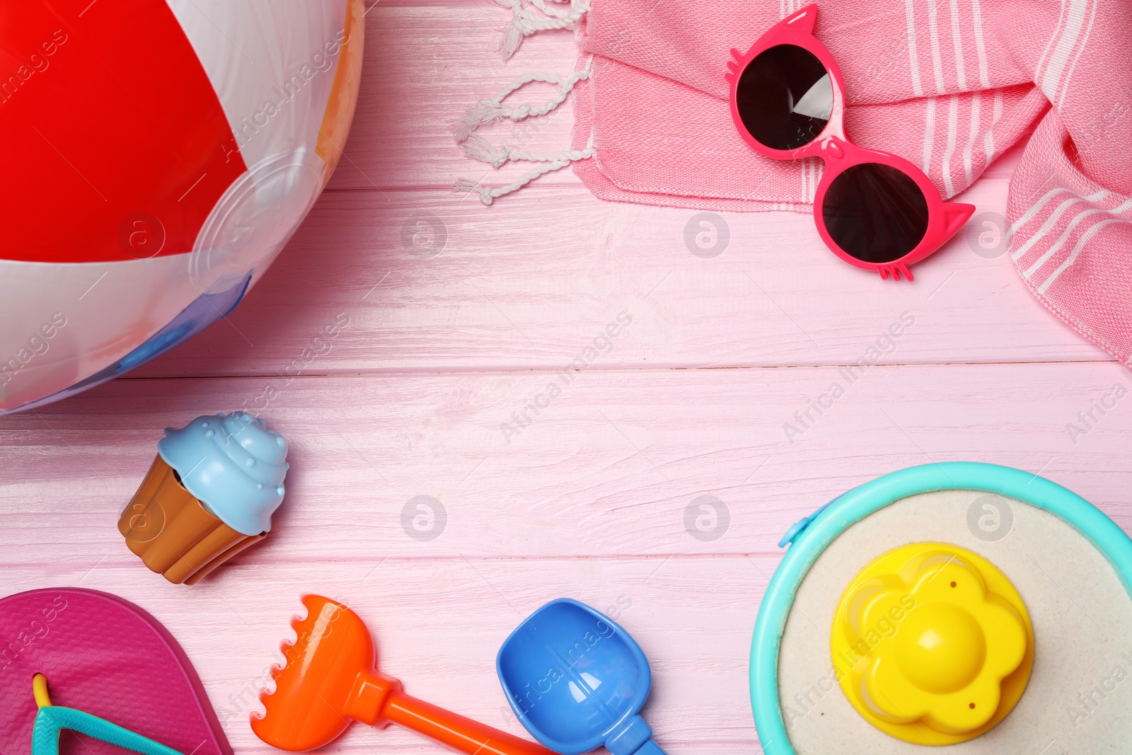 Photo of Flat lay composition with beach toys on color wooden background. Space for text