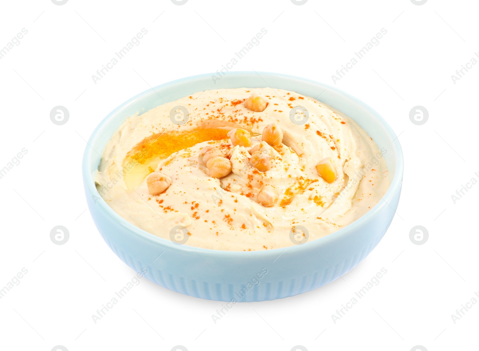 Photo of Tasty hummus with garnish in bowl isolated on white