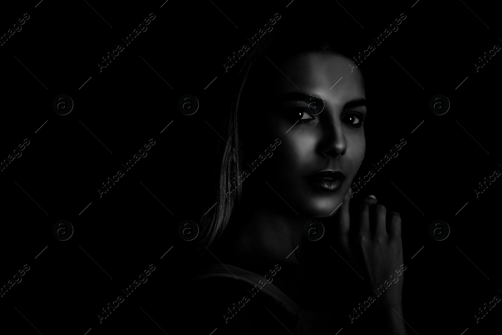 Image of Silhouette of woman in darkness. Portrait on black background