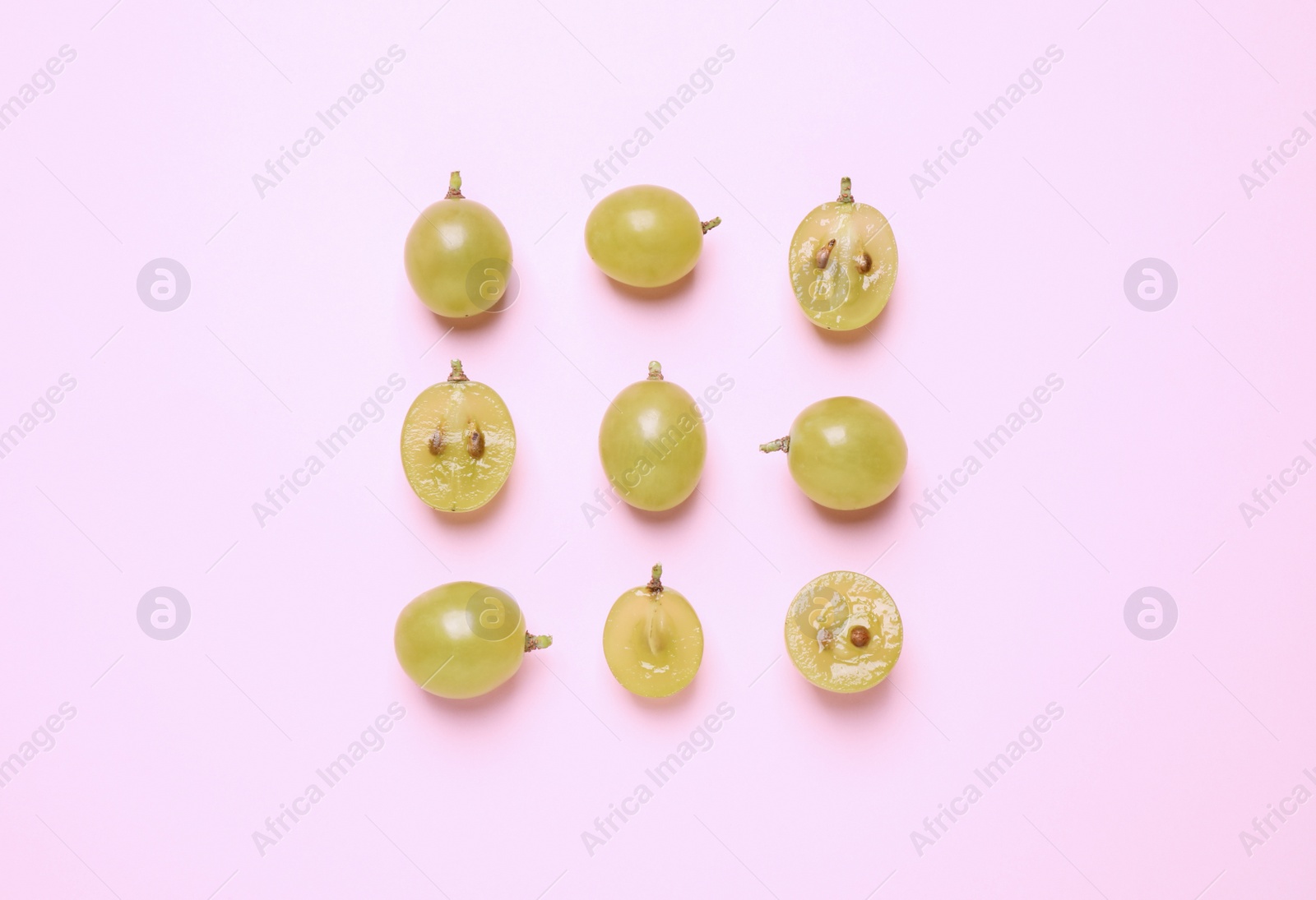Photo of Flat lay composition with fresh ripe grapes on pink background
