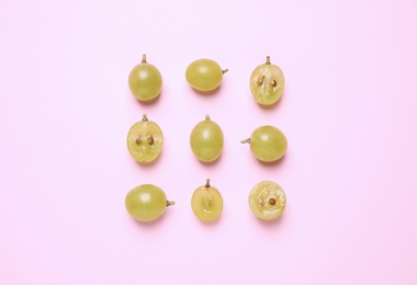 Flat lay composition with fresh ripe grapes on pink background