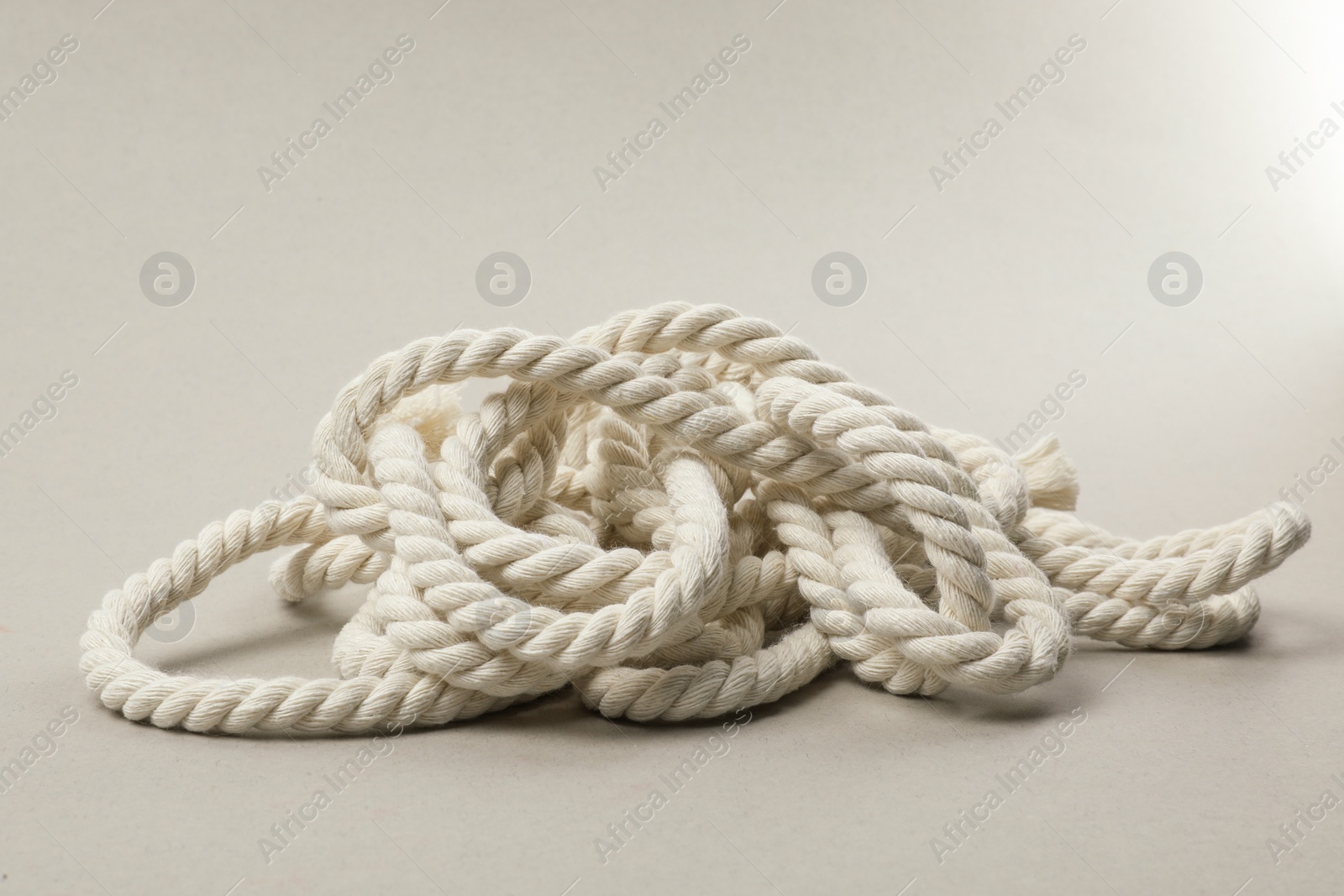 Photo of Bundle of hemp rope on light grey background