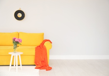 Photo of Elegant living room interior with comfortable sofa and table