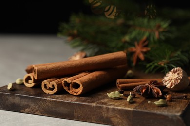 Photo of Board with different aromatic spices on table, closeup