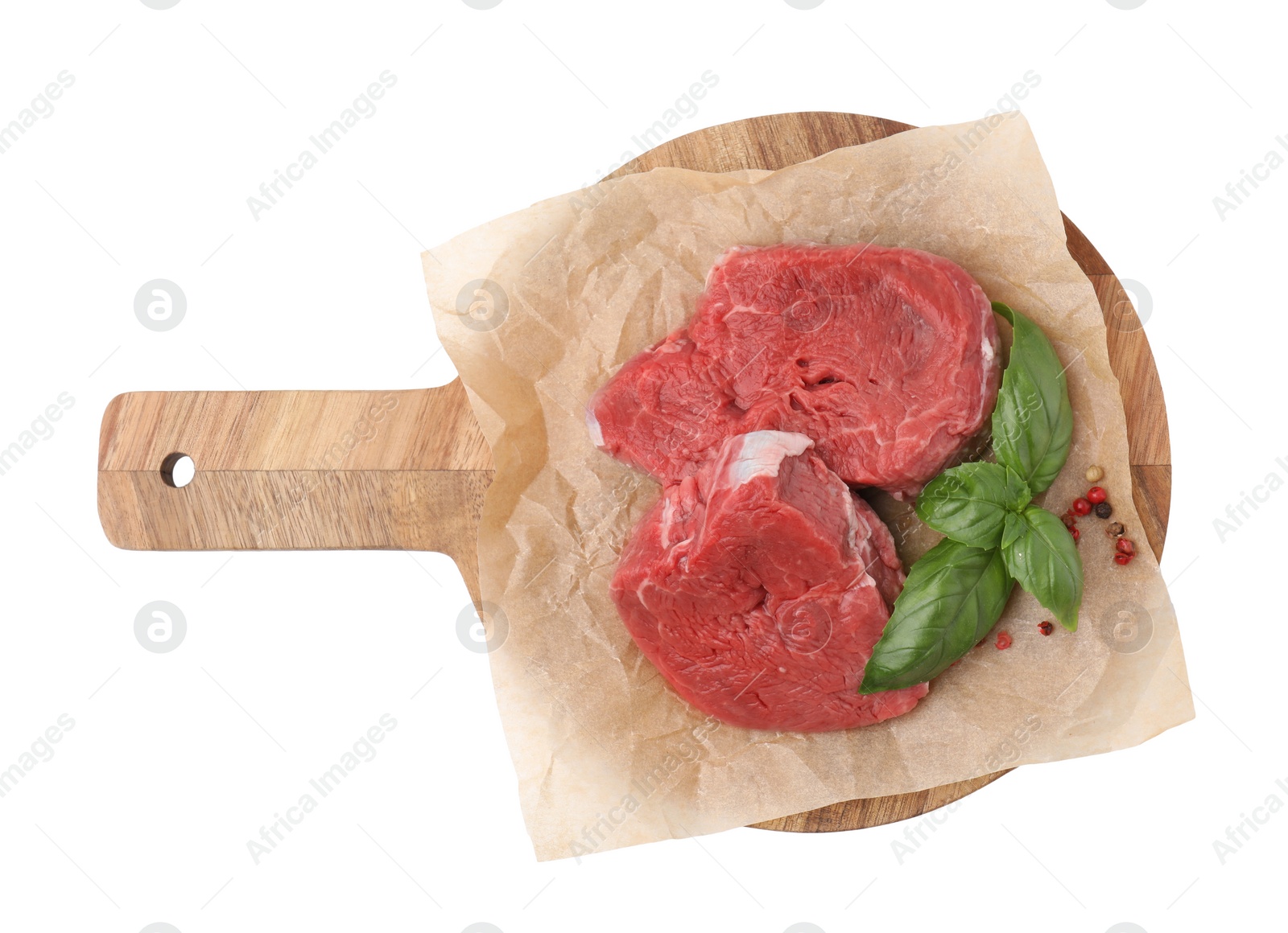 Photo of Fresh raw cut beef with basil leaves isolated on white, top view