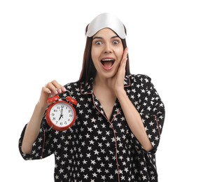 Photo of Emotional overslept woman with alarm clock on white background. Being late concept