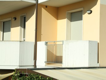 Modern residential building with balconies on sunny day