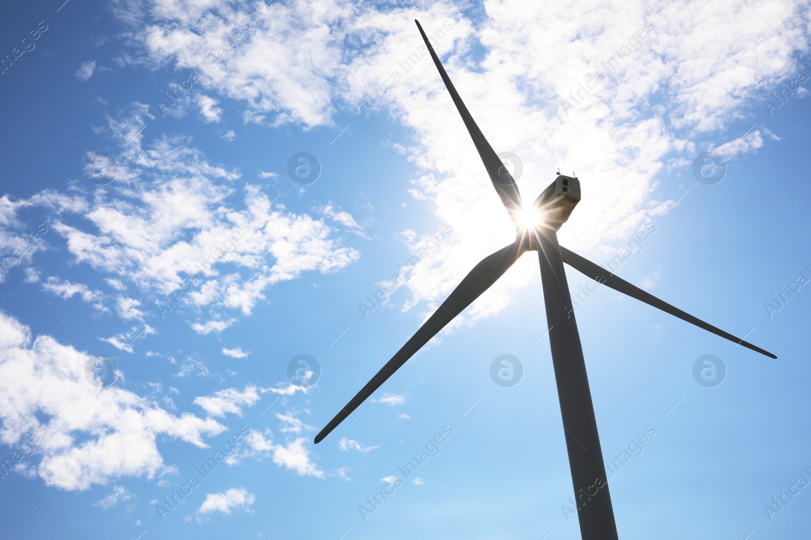 Photo of Wind turbine against beautiful blue sky, low angle view. Alternative energy source