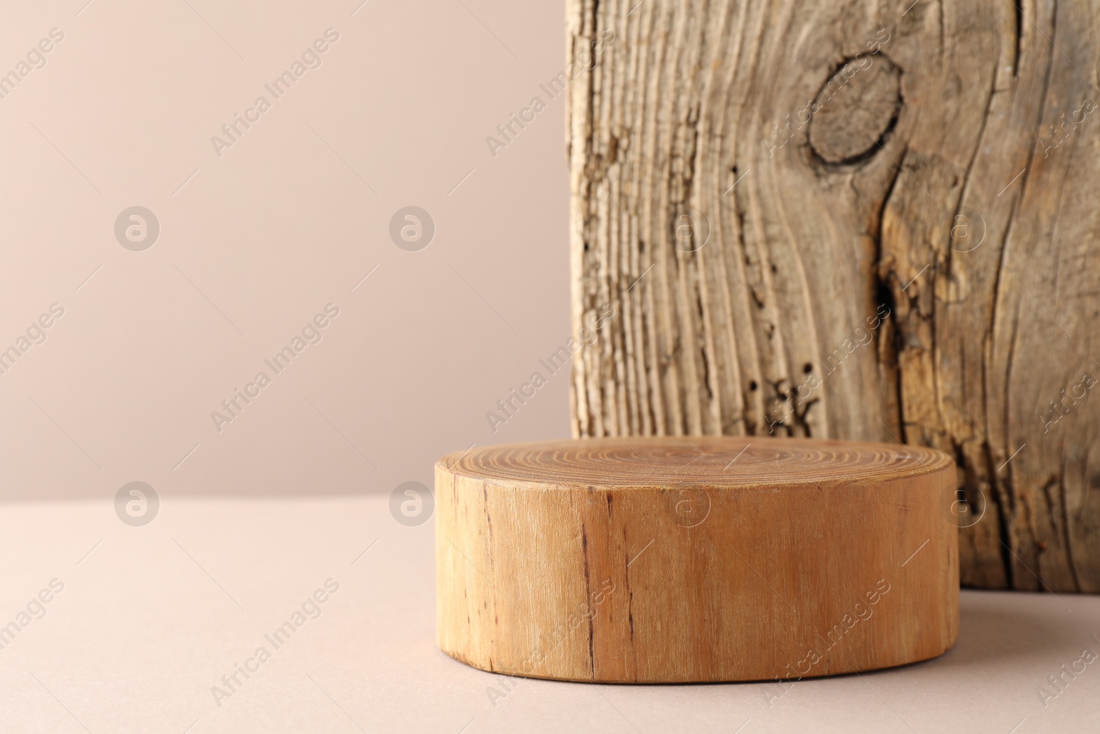 Photo of Presentation for product. Wooden podium on beige background. Space for text