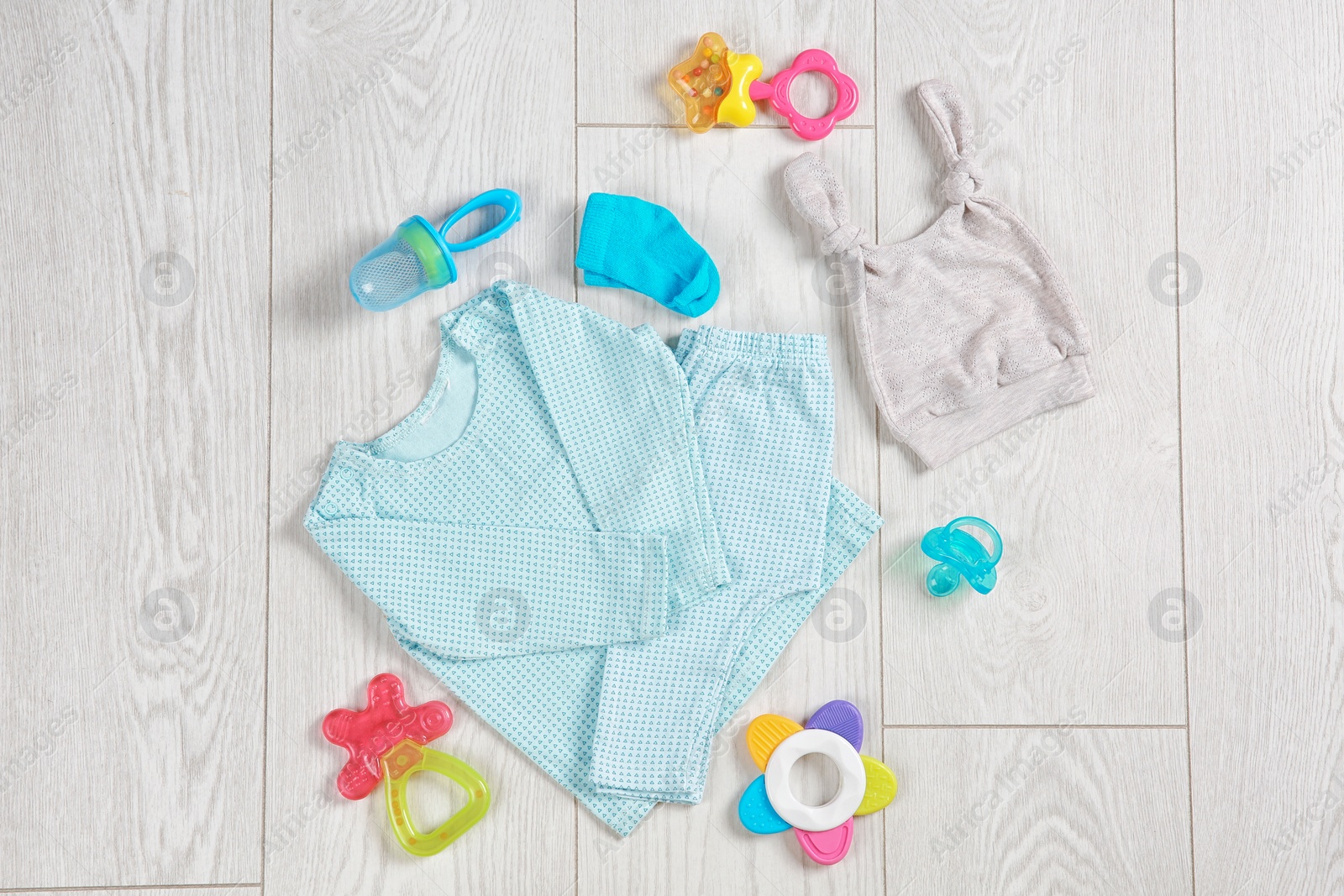 Photo of Flat lay composition with stylish child clothes and accessories on wooden background