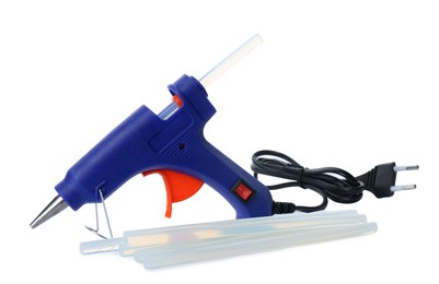 Photo of Blue glue gun and sticks on white background