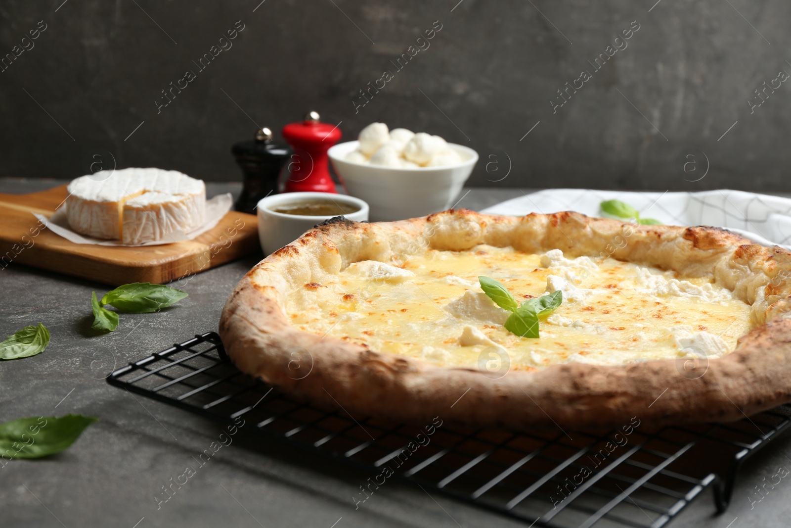 Photo of Delicious hot cheese pizza on grey table