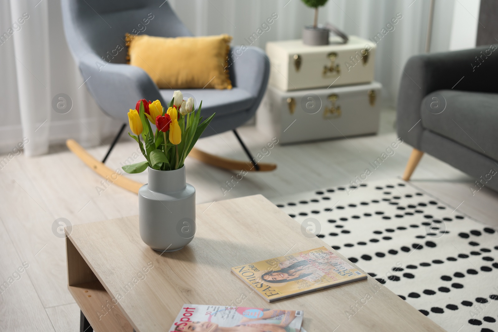 Photo of Beautiful tulips in vase on coffee table indoors, space for text