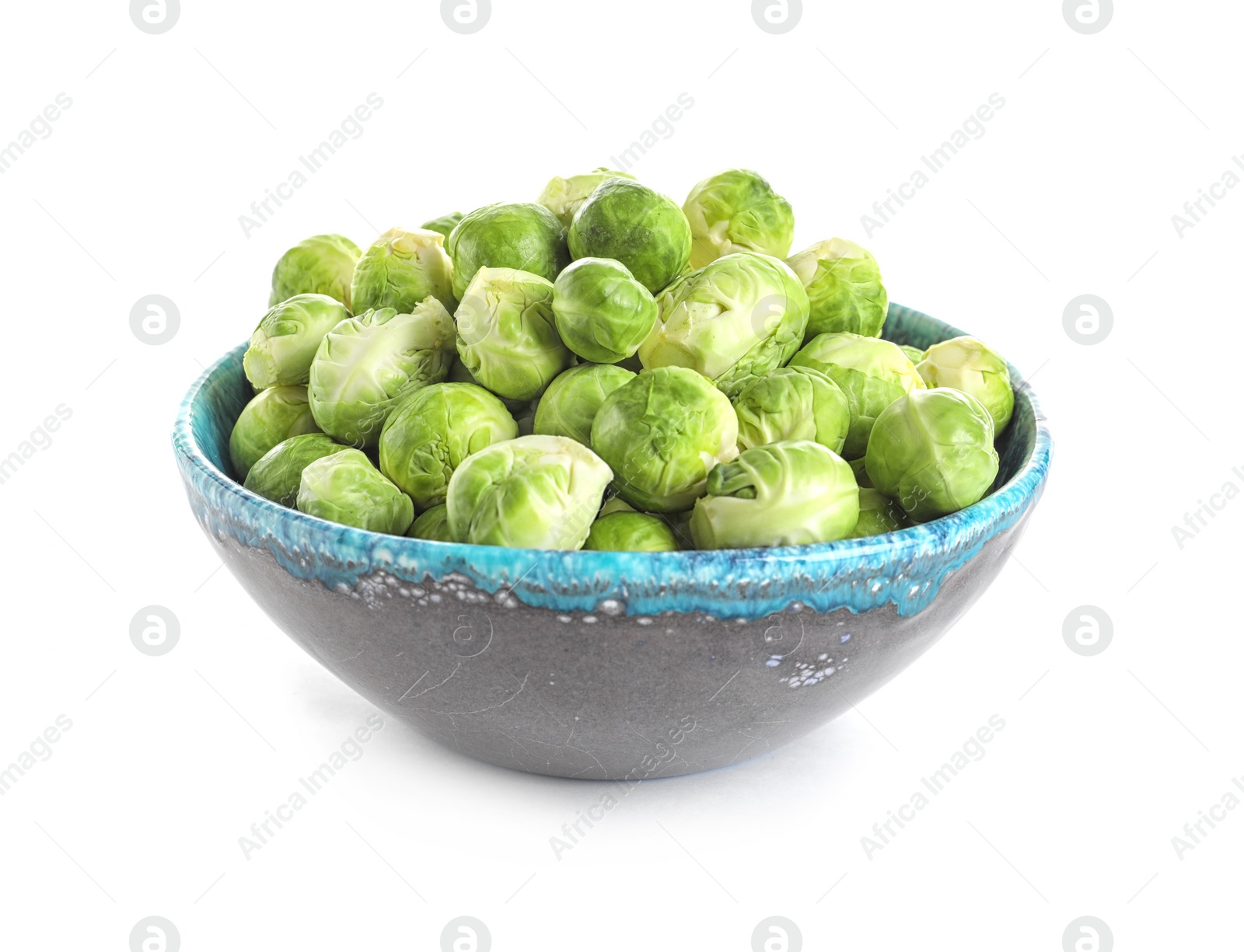 Photo of Bowl of fresh Brussels sprouts isolated on white