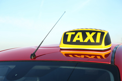 Photo of Roof light with word TAXI on car outdoors