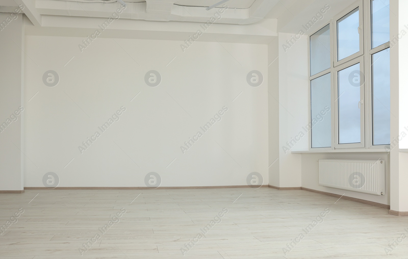 Photo of New empty room with clean windows and white walls