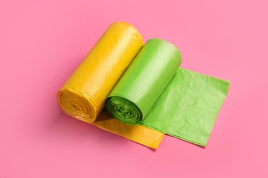 Photo of Rolls of garbage bags on pink background
