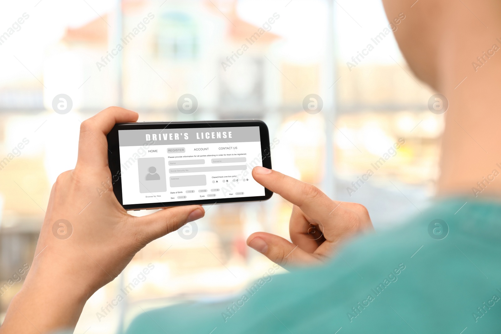 Image of Man filling in driver's license form online on website using smartphone, closeup