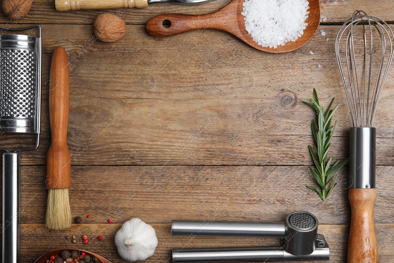 Photo of Frame made of cooking utensils and fresh ingredients on wooden table, flat lay. Space for text