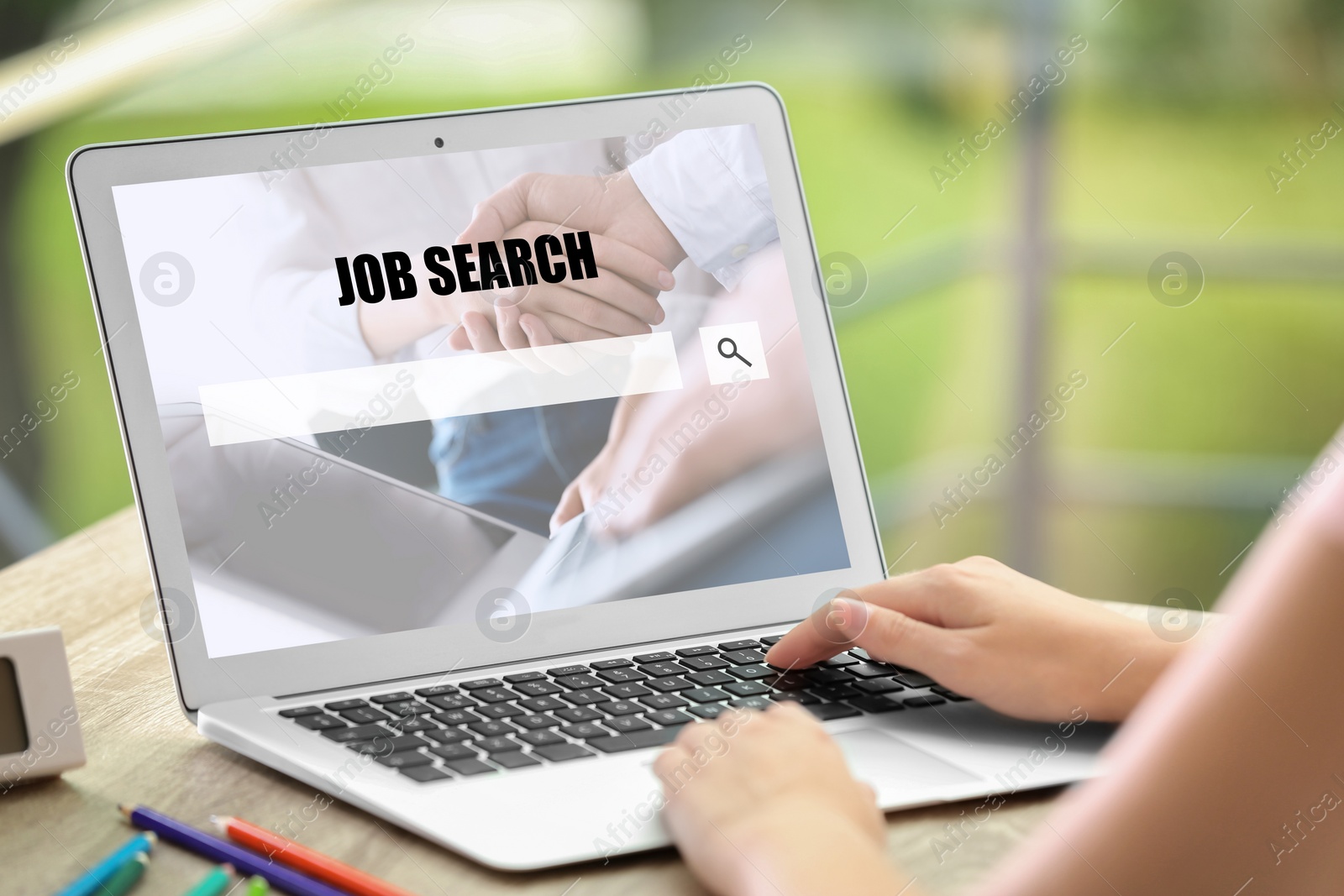 Image of Woman searching job with laptop at wooden table, closeup 