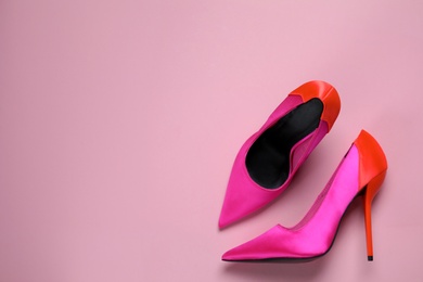 Photo of Pair of beautiful shoes on pink background, top view. Space for text