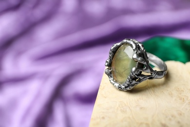 Photo of Beautiful silver ring with prehnite gemstone on textured surface. Space for text