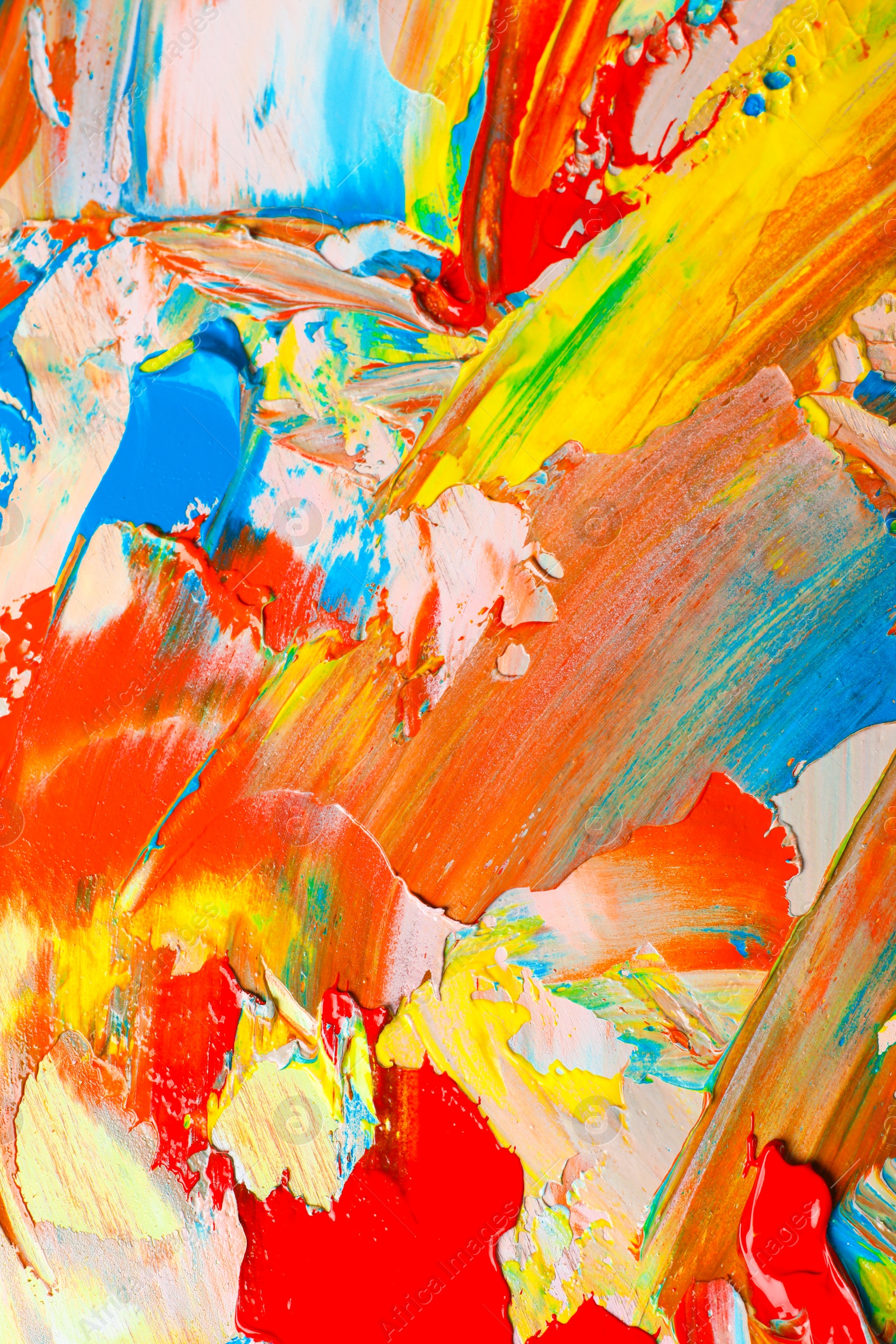 Photo of Closeup view of artist's palette with mixed bright paints as background