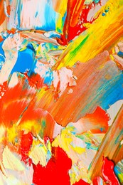 Photo of Closeup view of artist's palette with mixed bright paints as background