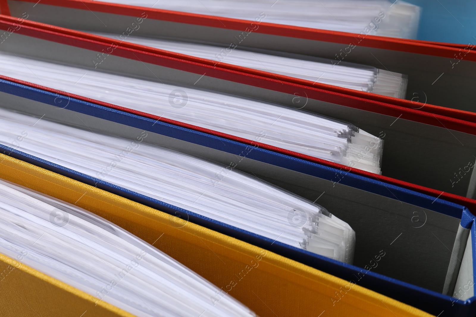 Photo of Colorful binder office folders as background, closeup