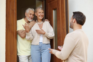 Photo of Friendly relationship with neighbours. Man visiting elderly couple