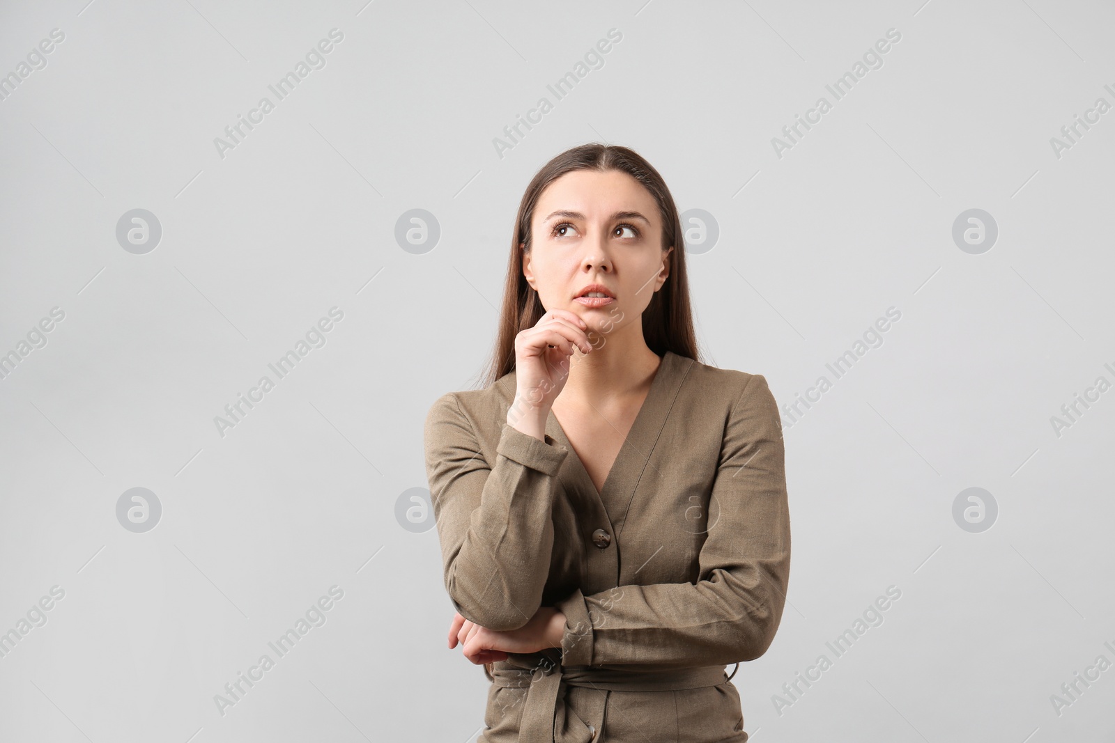 Photo of Portrait of young woman on light grey background. Personality concept