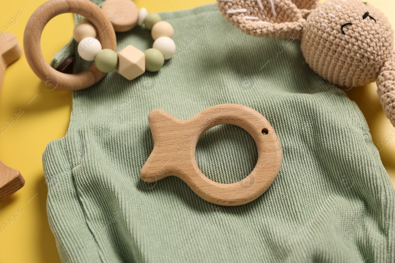 Photo of Different baby accessories on yellow background, closeup